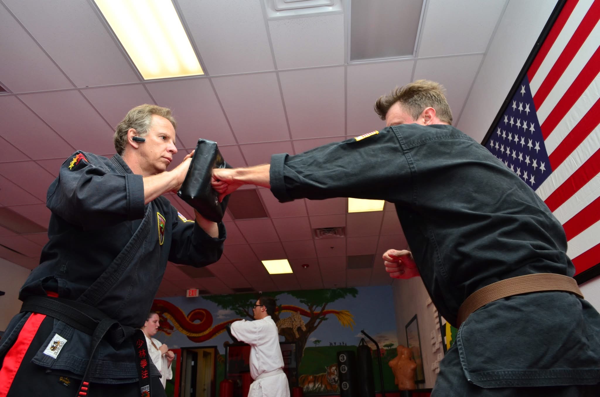 A karate sparring match adult versus teenager.